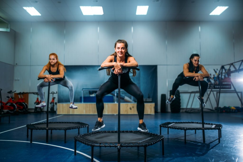 Women on trampoline in motion, fitness training